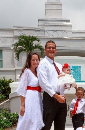 A young couple prepares to be sealed as a family with their children