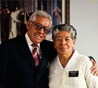 Senior missionary couple serving near a Temple.